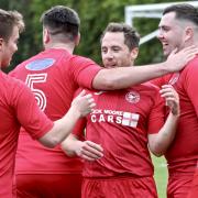 Goalscorer Jordi Mulvany celebrates with his Clanfield teammates after netting against Almondsbury   Picutre: Paul Gibbens
