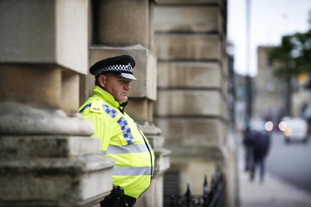 Police officer outside Oriel College in Oxford. Photo: Ed Nix