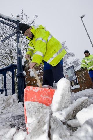 Oxford City Council contractor Peter Schoen shovels snow from pavement at Hythe Bridge Street, as colleague Peter Wilson applies grit.

Pic: Damian Halliwell