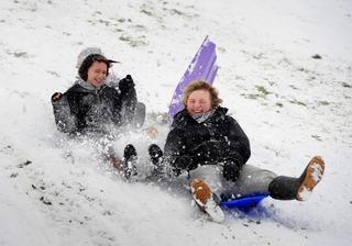 Jess Hayes, 14, and Sam Reynolds, 17, shoot down the hill on the snow in Didcot.
Picture by: David Fleming