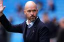 Erik Ten Hag waves from the touchline