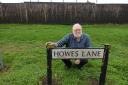 Chair of Derwent Green Residents Group, Stephen Rand, next to Howes Lane road sign