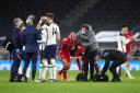 Liverpool's Thiago Alcantara receives treatment on a head injury