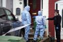 Police forensics officers attend the scene where the bodies were found in Belvedere (Yui Mok/PA)