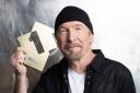 U2’s The Edge poses with his Official Number 1 Album Award for Songs Of Surrender from the Official Charts Company (Emily Quinn)