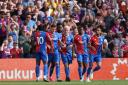 Will Hughes (centre) celebrates with team-mates after scoring Palace’s equaliser (Steven Paston/PA)