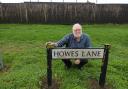 Chair of Derwent Green Residents Group, Stephen Rand, next to Howes Lane road sign