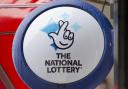 National Lottery sign outside a newsagent in north London (Yui Mok/PA)