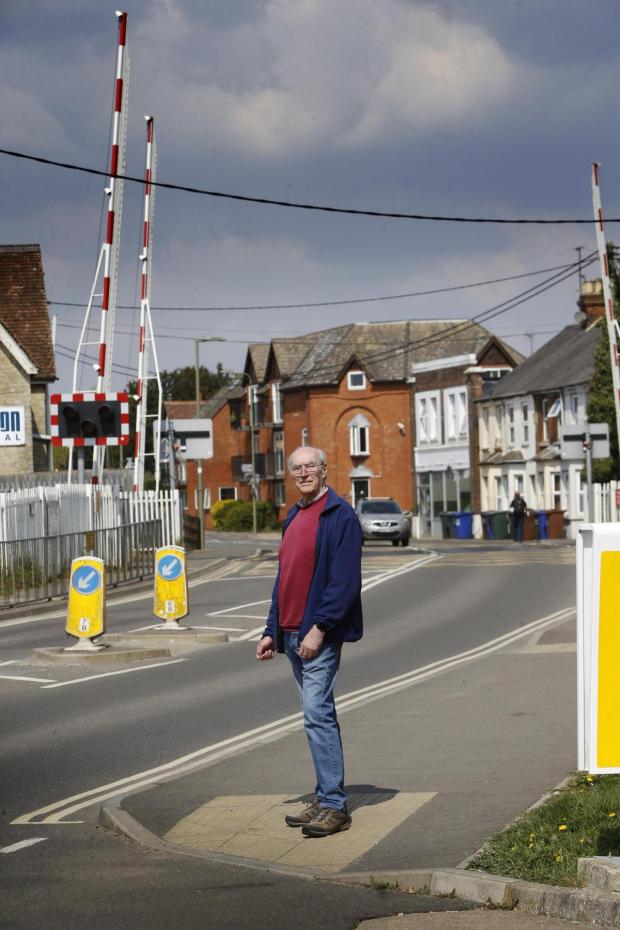 Bicester Advertiser: Councillor John Broad at the London Road level crossing. Pic by Ed Nix