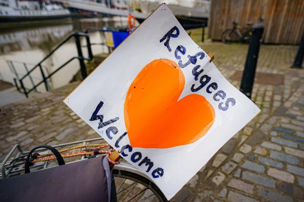 Bicester Advertiser: Refugees welcome sign. Credit: PA